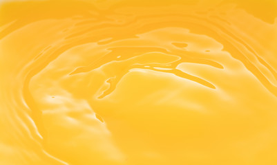 a swirling wave on the surface of orange juice.