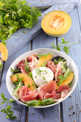 summer salad with cantaloupe, prosciutto ham and mozzarella