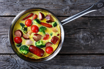 baked omelet or frittata with sausages, broccoli
