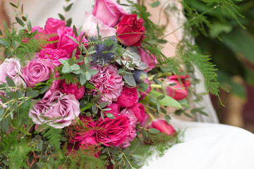 Beautiful bright wedding bouquet close-up. wedding purple boho bouquet in bride's hands