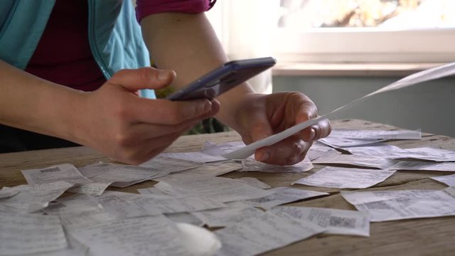 The woman uses the app on her mobile phone to scan the QR code and save the information about purchases in electronic form to compile personal purchase statistics and receive cashback