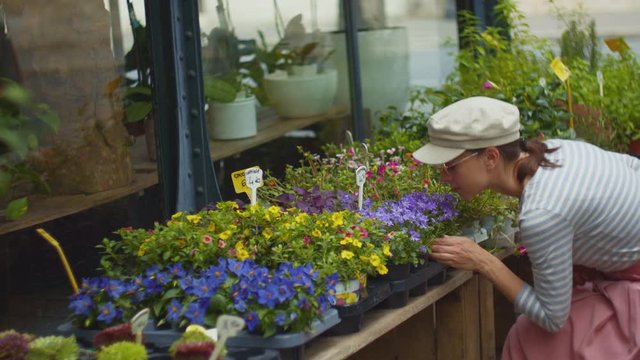 Young woman in a flower shop in Paris