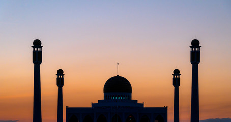 Mosque at sunset in silhouette