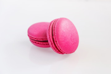 Strawberry macarons on white background