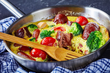 hot frittata with sausage in a frying pan