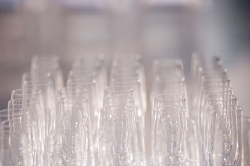 many empty glasses for alcoholic beverages. glass goblets on the shelf.