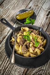 Italian pasta shells with beef sauce in cast iron pan.