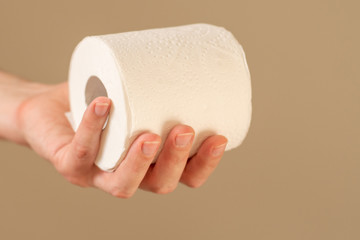 Man's hand holding and giving toilet paper roll