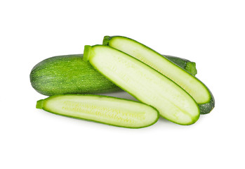 whole and sliced fresh zucchini on white background