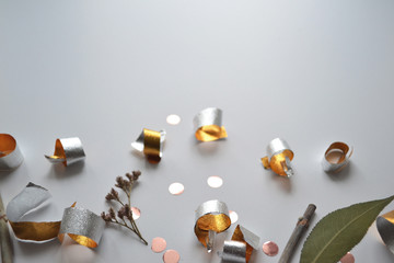 festive gold confetti and foil on a gray background