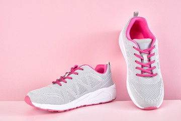 Running sports shoes on pink background, Pair of fashion stylish sneakers