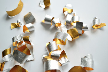 golden confetti shavings on gray background close-up