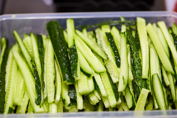 Sliced cucumbers on cutting board. Vegetables ready for salad. Tasty diet Vegetarian food