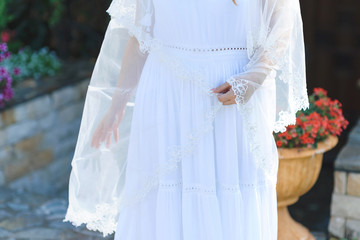 bride holding veil over dress