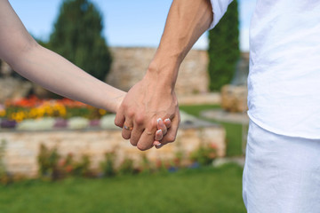 couple holding hands at park