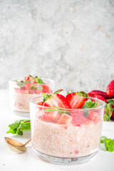Set various fruit overnight oatmeal. Oats porridge with strawberry, bananas, chocolate, nuts in small portion jars. Summer breakfast oatmeal. Healthy vegan diet snack.