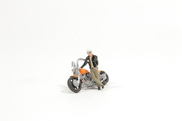 Obraz na płótnie Canvas Mini Figure Ride Motorcycle at the board