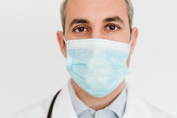 portrait of doctor wearing protective mask and gloves indoors. Corona virus concept