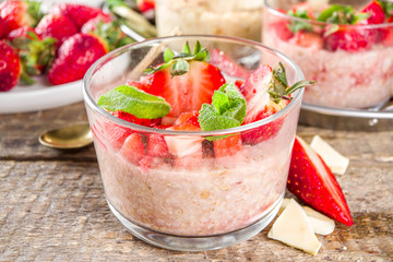 Set various fruit overnight oatmeal. Oats porridge with strawberry, bananas, chocolate, nuts in small portion jars. Summer breakfast oatmeal. Healthy vegan diet snack.
