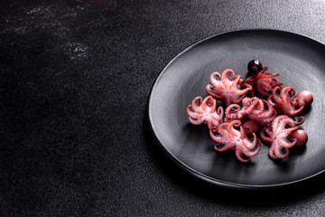 Seafood Baby octopus salad in a black plate