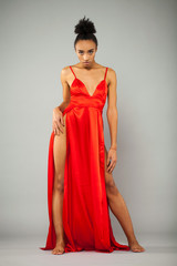 Young african woman in long red dress