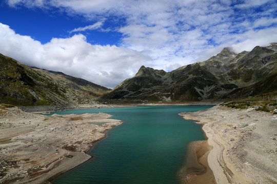 Lago di Montespluga with village of Montespluga and Alps, Italy