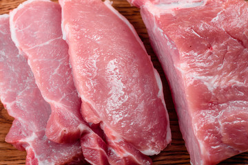 Fresh pieces pork ready to cook on a dark background in the kitchen