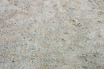 Yellow sand and small stones.