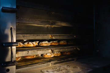 Dessert bread baking in oven. Production oven at the bakery. Baking bread. Manufacture of bread.