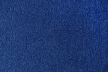 Classic blue felt background. The surface of the fabric texture.