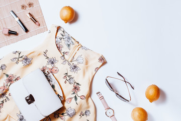 Fashion female clothes and accessories for beach destinations or summer vacation. Flat lay with woman white clothing, straw hat and purse, make up on white background, woman travel fashion concept