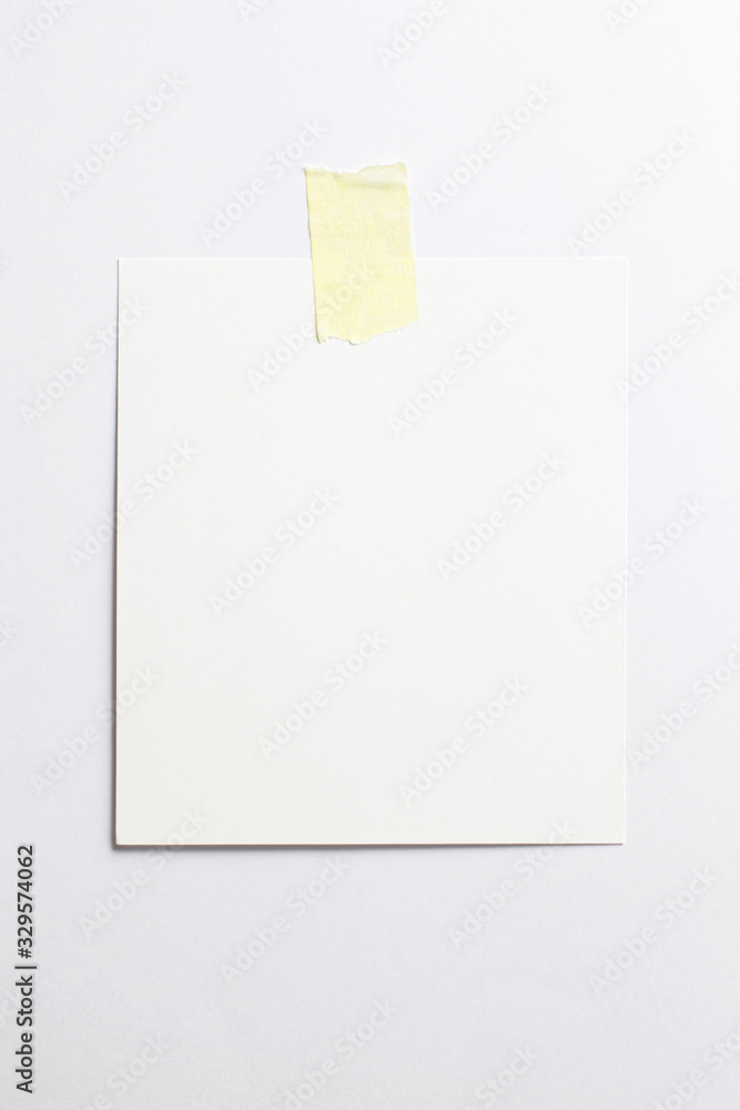 Wall mural Blank polaroid photo frame with soft shadows and yellow scotch tape isolated on white paper background as template for graphic designers presentations, portfolios etc.