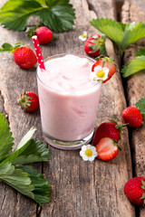 Fresh milk, strawberry on wooden table, assorted protein cocktail with fresh fruits. Natural background.