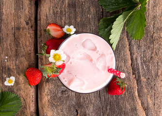 Fresh milk, strawberry on wooden table, assorted protein cocktail with fresh fruits. Natural background.