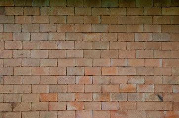 Old red brick wall with blurred patterned background