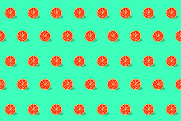 Seamless pattern with Grapefruit slice on bright light green background. Trendy sunlight Summer pattern. Minimal summer concept. Pastel color design.