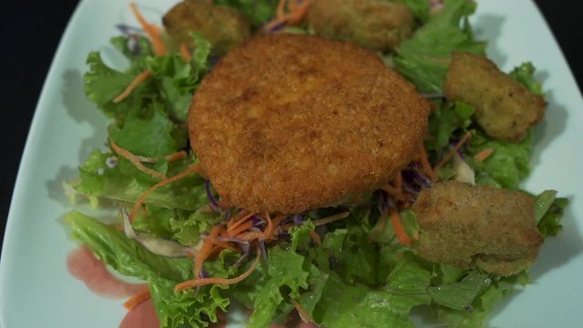 Broccoli And Cheese Tots Being Placed On Chicken Salad