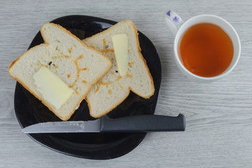 breakfast with toasted bread, butter and cup of tea