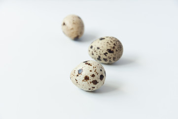 Quail eggs on a white background. Bird spotted eggs. Several objects. Healthy food.