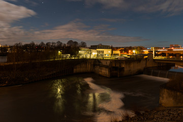 Fototapeta na wymiar Hydroelectric power plant on the river Danube in Regensburg, Bavaria during cloudy night with stars