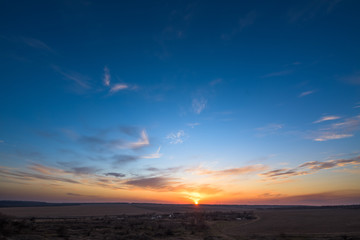 panorama of a blue-pink sunset with clouds of pink hues. sunset on the horizon. dramatic sky. photo for the banner. space for text.