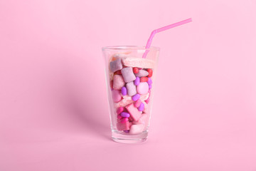 Glass with different chewing gums on color background - obrazy, fototapety, plakaty