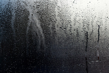 after the storm, water drops and condensation in a window glass