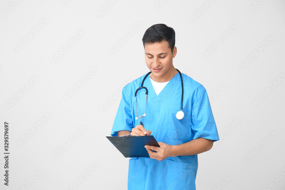 Sticker Handsome male doctor on light background