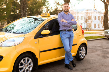 Portrait of handsome taxi driver outdoors