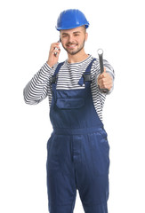 Handsome male worker talking by mobile phone on white background