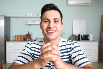 Young man using video chat at home