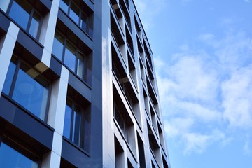 Modern office building facade abstract fragment, shiny windows in steel structure