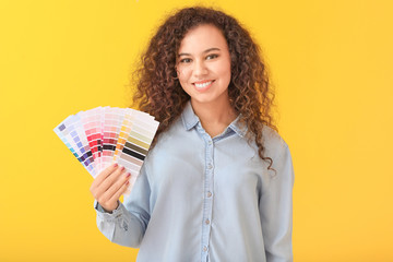 African-American woman with color palettes on yellow background