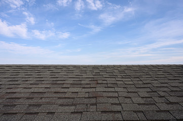 Dark roof tiles with blue sky